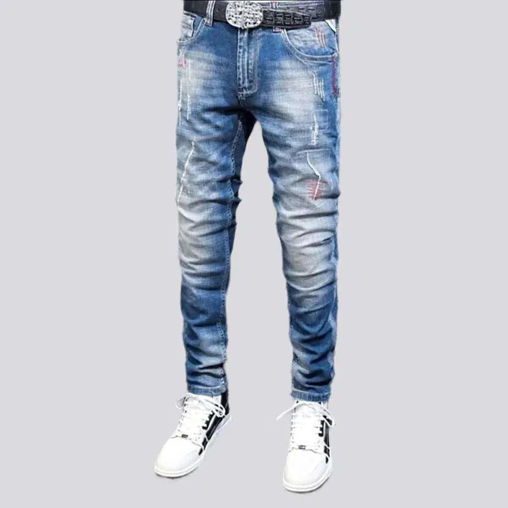 Sanded men's whiskered jeans