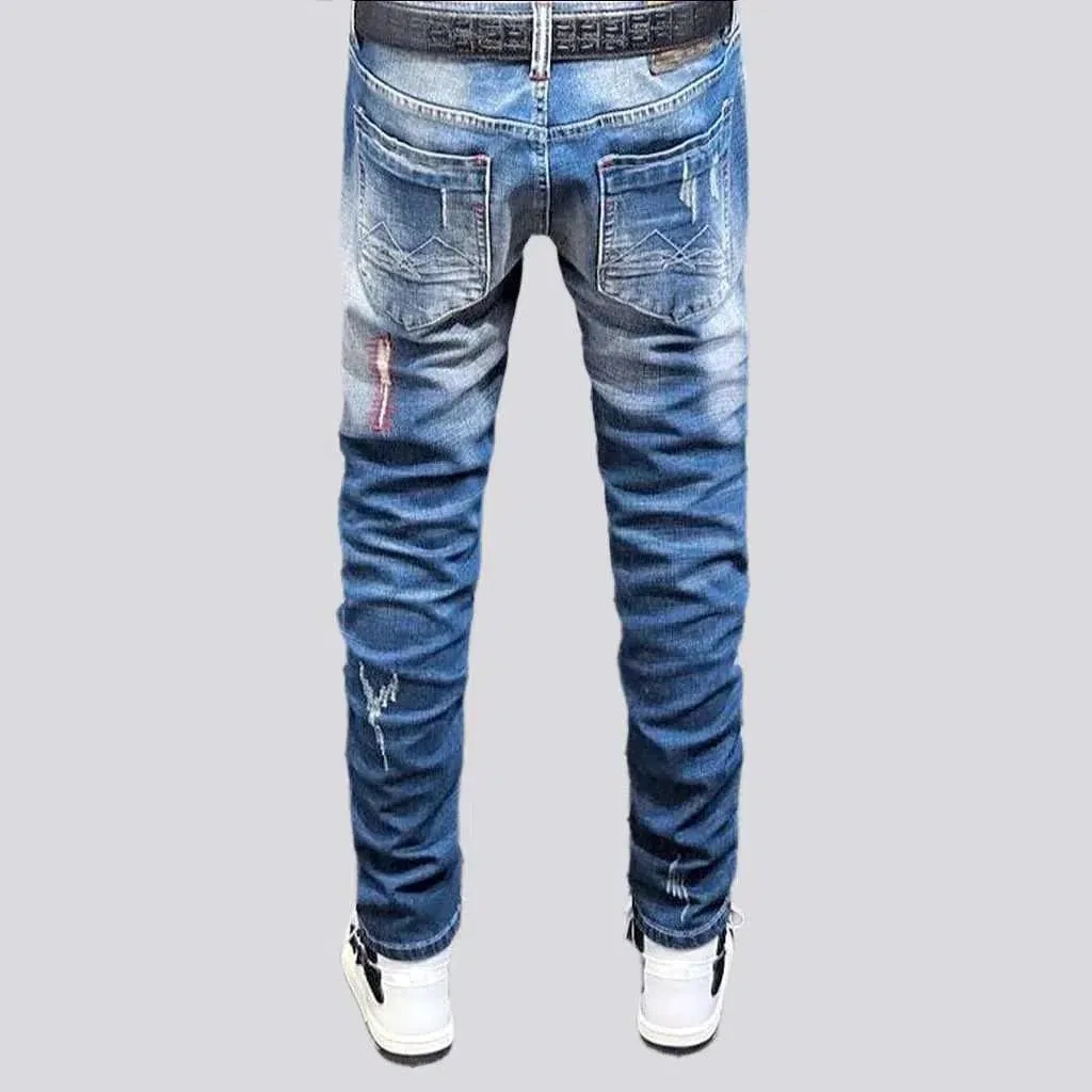 Sanded men's whiskered jeans